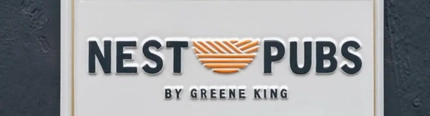The Nest Pubs logo on a wall plaque.