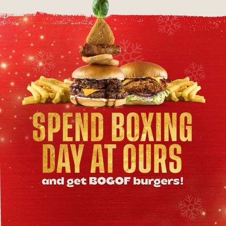 A graphic banner promoting 'Spend boxing day at ours and get BOGOF burgers.' at Flaming Grill venues.