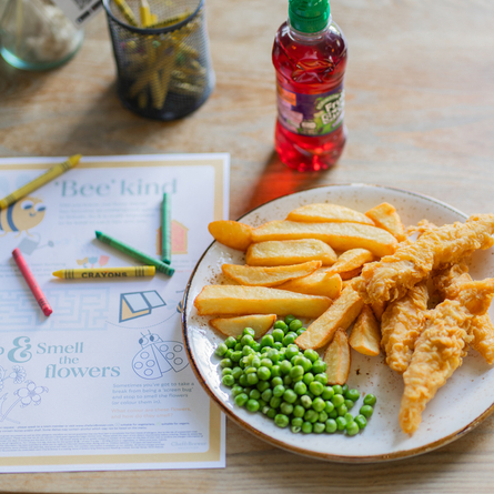 A young guests portion of fish goujons with chips and peas served at Chef and Brewer venues.
