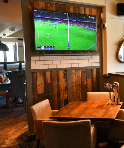 interior of the restaurant and seating area with TV