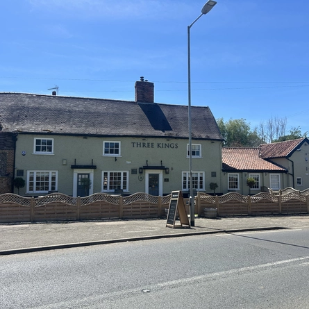 An image of the exterior facade with venue signage and car park at The Three Kings.