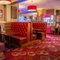 The interior restaurant seating area of The Royal Horse, with wooden tables and upholstered booth seating.