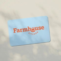 A light blue Farmhouse Kitchens gift card on a table.