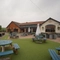 Exterior facade and beer garden of a pub with a play area.