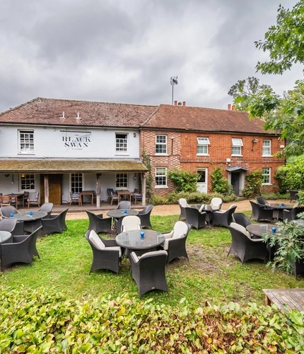 The exterior rear view of the venue and beer garden seating area at The Black Swan.