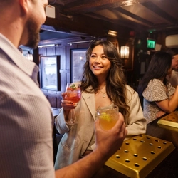 An interior shot of people enjoying summer drinks at the bar at Urban Core & Heritage venues.