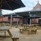 An image of the exterior beer garden seating area and partial undercover section with the rear of the venue in the background at The Guild.