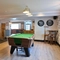 Interior seating area of a pub with a bar, a pool table and a gambling machine.