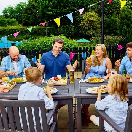 A family eating and drinking outside in a beer garden