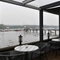 Exterior seating area of a pub next to a body of water.