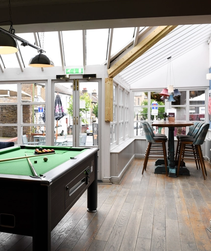 Pool table in interior games area of a pub restaurant