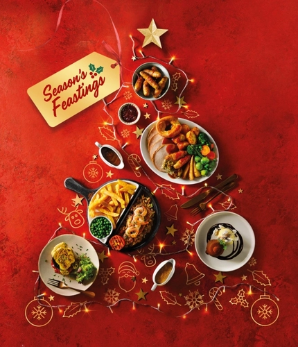 A variety of dishes arranged in the shape of a Christmas tree, with a gift tag that says 'seasons feastings' attached to the top of the tree.