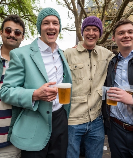 An image of 4 friends stood within the beer garden area with drinks during The Boat Race event at The Crabtree.