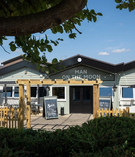 The exterior facade, signage and beer garden seating area at The Man On The Moon in Ipswich.