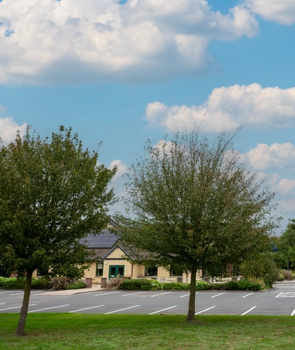 An image of the exterior of the venue including venue branded signage and car park area at The Farmhouse Kitchen Willington.