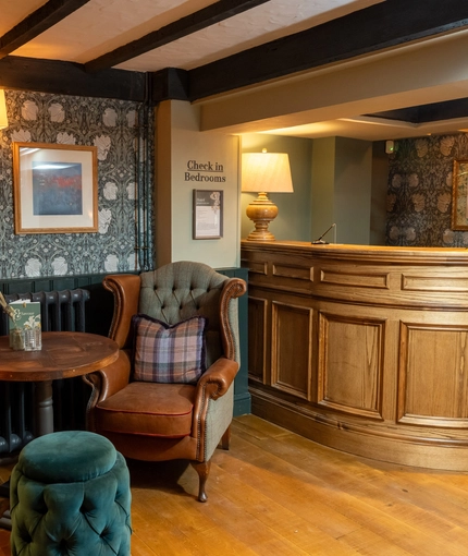 The reception area at Himley House, with two armchairs and a check in desk.