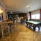 Interior dining area of a pub with a TV.