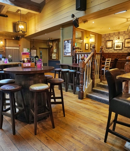 Interior dining area of a pub with a TV.