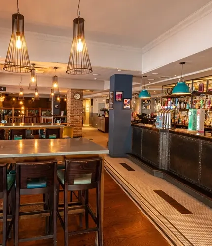 Some bar tables next to the bar in the Finery.