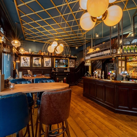 The interior bar and restaurant seating area with feature fireplace at The Blue Posts.