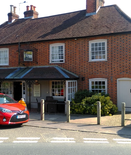 exterior facade of a pub with a seating area