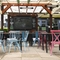 Exterior beer garden of a pub with a gazebo, a seating area and a TV.