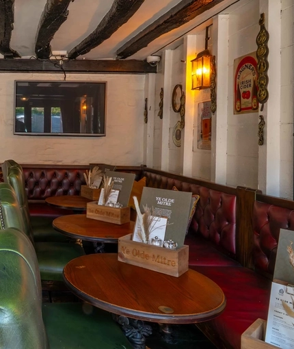 The interior restaurant seating area with TV, at Ye Olde Mitre in Barnet.