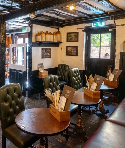 The interior restaurant seating area of Ye Olde Mitre in Barnet.