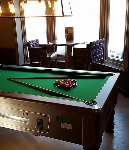 A pool table within the interior restaurant seating area at The Station.