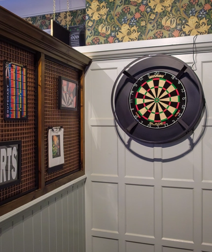 The interior pub games area with dart board at the Tudor Arms.