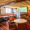 Interior dining area of a pub with a TV and a fireplace.