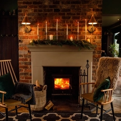 Seats in front of a fireplace at The Boat.