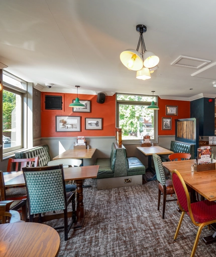 Interior dining area of a pub with a TV.