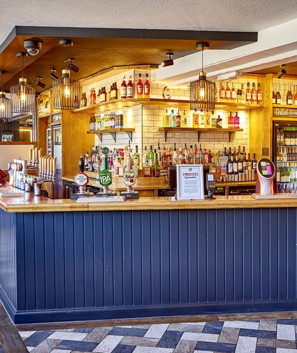 The bar, interior seating area and TV at The Good Intent in Hornchurch.