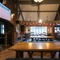 Interior dining area of a pub with a fireplace and a TV.