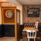 The interior restaurant and seating area with games area including a dart board at the Sussex Yeoman.