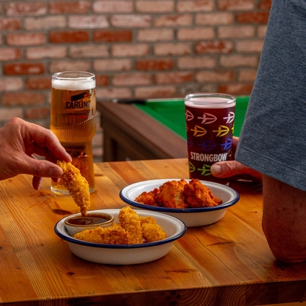 An image of 2 people enjoying a snack/sharer within the interior of a Hungry Horse venue.