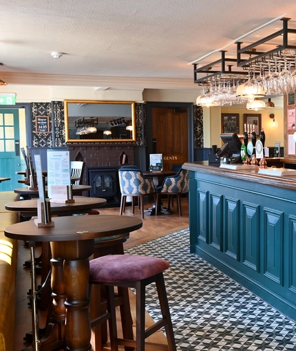 The interior bar and restaurant seating area with feature fireplace at The Yorkshire Grey.