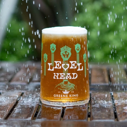 A pint of Level Head on an outdoor table in the rain.