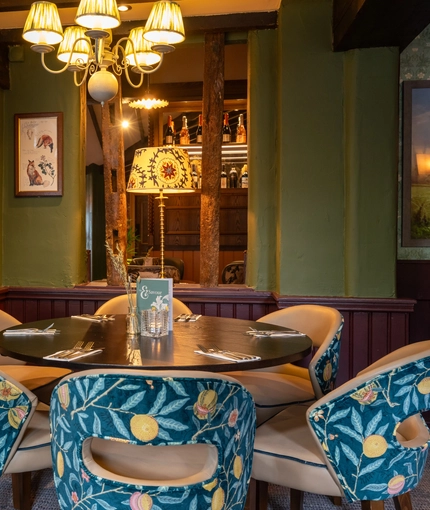 A table next to some wooden beams in the restaurant area of the Grapes.