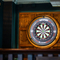A close up view of an illuminated dartboard on a wood panelled wall inside the Scholars Arms.