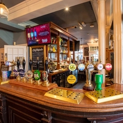 The bar with TV inside The Tabard in Chiswick.