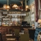 Dark wood bar with all of the branded bottles lined up neatly on the bar of the Sherlock Holmes venue in St James'