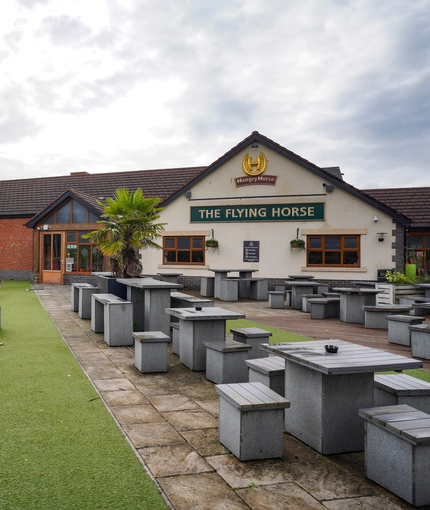 exterior beer garden of a pub with a seating area and a play area