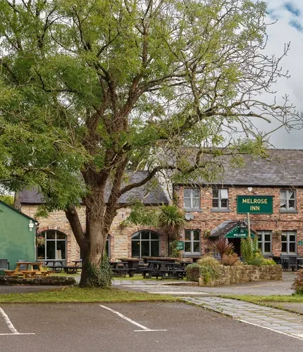 Exterior facade of a pub with a seating area.