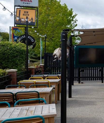 The exterior beer garden and seating area with venue signage for the Hem Heath.