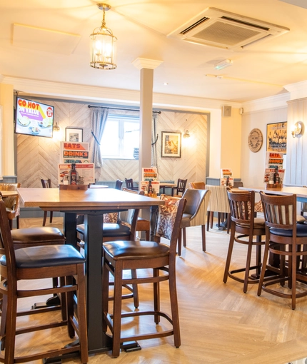 The interior restaurant and seating area with TV at the Poachers 