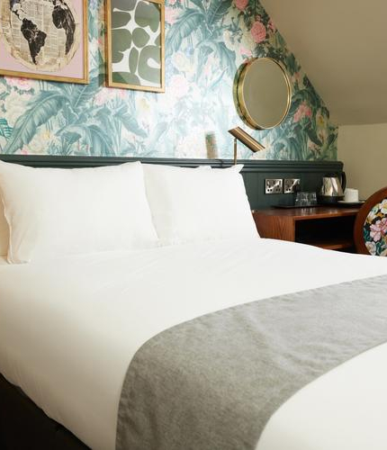 A bed in a hotel room of The Narborough Arms.