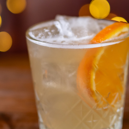 a cocktail sitting on a wooden table of a pub