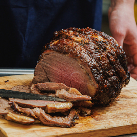 A Chef carving a joint of beef at the carvery deck at Crafted Venues.